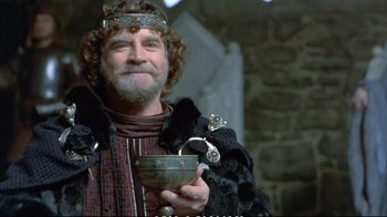 Movie still from “Hamlet” (1990), directed by Franco Zeffirelli – A man with a beard holding a bowl in his hand; Close Up shot, Low angle