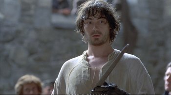 Movie still from “Hamlet” (1990), directed by Franco Zeffirelli – A person holding a sword in his hand; Close Up shot, Low angle
