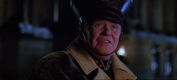 Movie still from “Hamlet” (1996), directed by Kenneth Branagh – An older man wearing a hat and a uniform; Close Up shot, Low angle