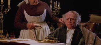 Movie still from “Hamlet” (1996), directed by Kenneth Branagh – An old man sitting in front of a woman; Close Up shot, High angle