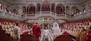 Movie still from “Hamlet” (1996), directed by Kenneth Branagh – A man and a woman standing in front of an audience; Extreme Wide shot, Low angle