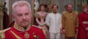 Movie still from “Hamlet” (1996), directed by Kenneth Branagh – A person wearing a suit and tie; Close Up shot, Over the shoulder angle