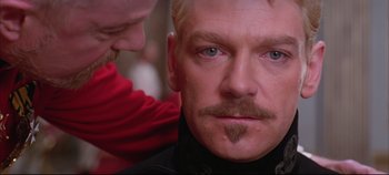 Movie still from “Hamlet” (1996), directed by Kenneth Branagh – A person with a mustache; Close Up shot, Over the shoulder angle