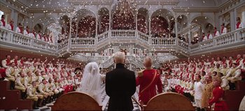 Movie still from “Hamlet” (1996), directed by Kenneth Branagh – A bride and groom are standing in front of a crowd of people; Wide shot, Low angle