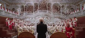 Movie still from “Hamlet” (1996), directed by Kenneth Branagh – A man standing in front of a painting of a crowd of people; Wide shot, Low angle