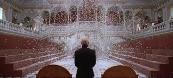Movie still from “Hamlet” (1996), directed by Kenneth Branagh – A man standing in front of an indoor stage; Wide shot, Low angle