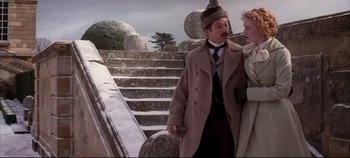 Movie still from “Hamlet” (1996), directed by Kenneth Branagh – A man and a woman standing next to each other on steps; Medium shot, Low angle