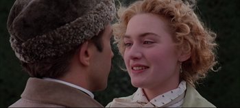 Movie still from “Hamlet” (1996), directed by Kenneth Branagh – A man and a woman face to face in front of trees; Close Up shot, Over the shoulder angle