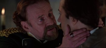 Movie still from “Hamlet” (1996), directed by Kenneth Branagh – An older man with a beard looking at a younger man; Close Up shot, Over the shoulder angle