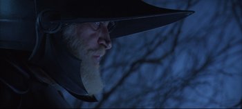 Movie still from “Hamlet” (1996), directed by Kenneth Branagh – A man with a long white beard wearing a black hat; Close Up shot, Low angle