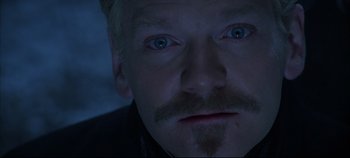 Movie still from “Hamlet” (1996), directed by Kenneth Branagh – A person with a mustache; Close Up shot, Over the shoulder angle