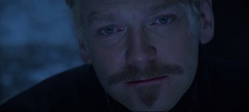 Movie still from “Hamlet” (1996), directed by Kenneth Branagh – A person with a mustache; Close Up shot, Over the shoulder angle