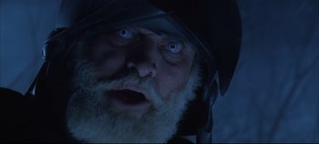Movie still from “Hamlet” (1996), directed by Kenneth Branagh – A person with a beard wearing a helmet; Extreme Close Up shot, Low angle