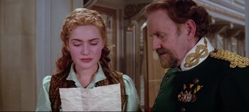 Movie still from “Hamlet” (1996), directed by Kenneth Branagh – A man and a woman standing next to each other in a room; Close Up shot, Over the shoulder angle