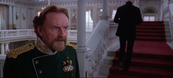 Movie still from “Hamlet” (1996), directed by Kenneth Branagh – A man in a military uniform standing in front of a staircase; Close Up shot, Over the shoulder angle