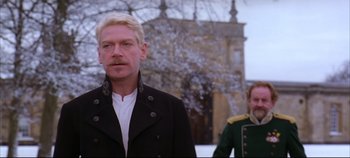 Movie still from “Hamlet” (1996), directed by Kenneth Branagh – A man and a woman standing next to each other in front of a building; Medium shot, Over the shoulder angle