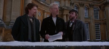 Movie still from “Hamlet” (1996), directed by Kenneth Branagh – A group of men standing next to each other holding papers; Medium shot, Low angle