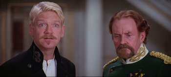 Movie still from “Hamlet” (1996), directed by Kenneth Branagh – Two men with mustaches are standing next to each other; Close Up shot, Over the shoulder angle