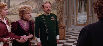 Movie still from “Hamlet” (1996), directed by Kenneth Branagh – A man in a military uniform standing next to a woman; Medium shot, Over the shoulder angle