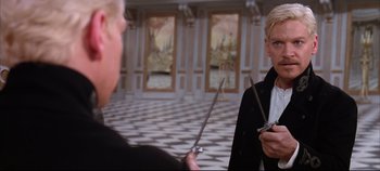 Movie still from “Hamlet” (1996), directed by Kenneth Branagh – A man holding a pair of scissors in his hands; Medium shot, Over the shoulder angle