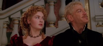 Movie still from “Hamlet” (1996), directed by Kenneth Branagh – A man and a woman in formal wear looking at each other; Close Up shot, Low angle