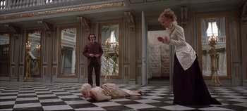 Movie still from “Hamlet” (1996), directed by Kenneth Branagh – Two women and a man are in a room; Wide shot, High angle
