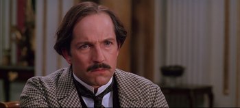 Movie still from “Hamlet” (1996), directed by Kenneth Branagh – A person wearing a suit and tie; Close Up shot, Low angle