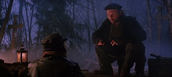 Movie still from “Hamlet” (1996), directed by Kenneth Branagh – A man in a hat is talking to another man in a forest; Medium shot, Over the shoulder angle