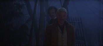 Movie still from “Hamlet” (1996), directed by Kenneth Branagh – A man standing next to another man in a forest; Medium shot, Over the shoulder angle