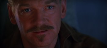 Movie still from “Hamlet” (1996), directed by Kenneth Branagh – A man's face with a mustache; Close Up shot, Over the shoulder angle