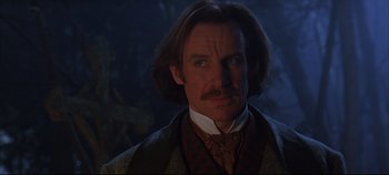 Movie still from “Hamlet” (1996), directed by Kenneth Branagh – A person wearing a suit and tie; Close Up shot, Low angle