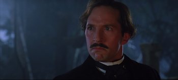 Movie still from “Hamlet” (1996), directed by Kenneth Branagh – A person wearing a suit and tie; Close Up shot, Low angle