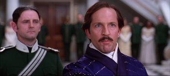 Movie still from “Hamlet” (1996), directed by Kenneth Branagh – A person with a mustache wearing a suit; Close Up shot, Low angle