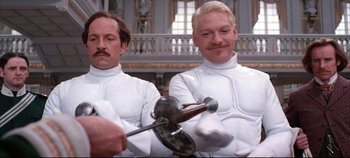 Movie still from “Hamlet” (1996), directed by Kenneth Branagh – A couple of men in white shirts and ties holding tools; Medium shot, Low angle