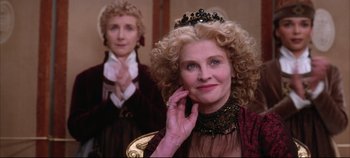 Movie still from “Hamlet” (1996), directed by Kenneth Branagh – A woman with curly blonde hair wearing a tiara; Close Up shot, Over the shoulder angle