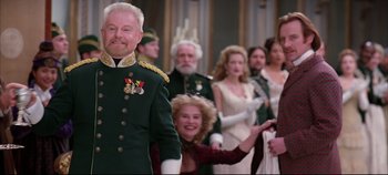 Movie still from “Hamlet” (1996), directed by Kenneth Branagh – A group of people standing next to each other in a room; Medium shot, Over the shoulder angle