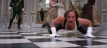 Movie still from “Hamlet” (1996), directed by Kenneth Branagh – A man with a white glove laying on the ground; Medium shot, Low angle