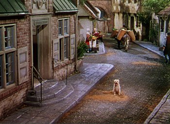 Movie still from “Hans Christian Andersen” (1952), directed by Charles Vidor – A dog sitting on the side of the street; Extreme Wide shot, High angle