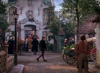 Movie still from “Hans Christian Andersen” (1952), directed by Charles Vidor – A group of people walking down a street; Wide shot, Over the shoulder angle