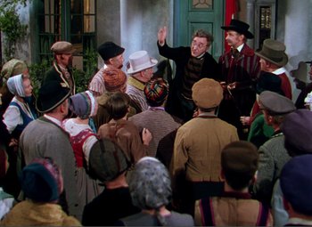 Movie still from “Hans Christian Andersen” (1952), directed by Charles Vidor – A group of people gathered in a room; Wide shot, High angle
