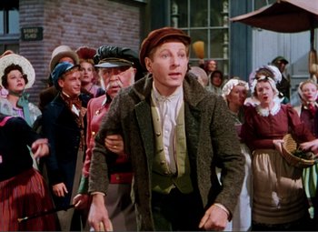 Movie still from “Hans Christian Andersen” (1952), directed by Charles Vidor – A group of people standing around a building; Medium shot, High angle