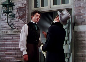 Movie still from “Hans Christian Andersen” (1952), directed by Charles Vidor – A man in a top hat talking to another man in a suit; Medium shot, Over the shoulder angle