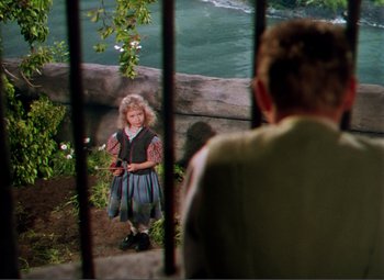 Movie still from “Hans Christian Andersen” (1952), directed by Charles Vidor – A young girl standing in front of a man; Wide shot, High angle