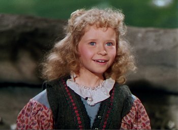 Movie still from “Hans Christian Andersen” (1952), directed by Charles Vidor – A young girl with blonde curly hair wearing a vest; Close Up shot, High angle
