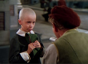 Movie still from “Hans Christian Andersen” (1952), directed by Charles Vidor – A young boy with a shaved head and an older man; Close Up shot, High angle