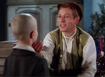 Movie still from “Hans Christian Andersen” (1952), directed by Charles Vidor – A young man talking to a young boy in front of a mirror; Medium shot, Over the shoulder angle