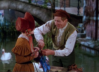 Movie still from “Hans Christian Andersen” (1952), directed by Charles Vidor – A man and a woman in a hat and dress; Medium shot, High angle