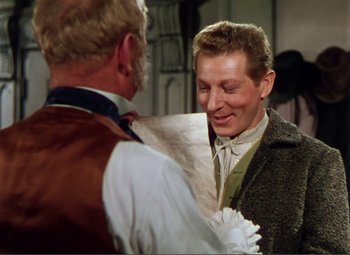 Movie still from “Hans Christian Andersen” (1952), directed by Charles Vidor – A man wearing a suit and tie standing next to another man wearing a tie; Medium shot, Over the shoulder angle