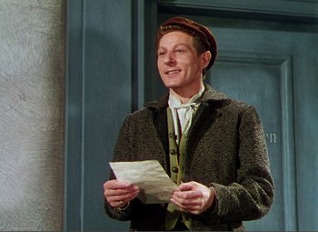 Movie still from “Hans Christian Andersen” (1952), directed by Charles Vidor – A man wearing a hat and holding a letter; Medium shot, Low angle