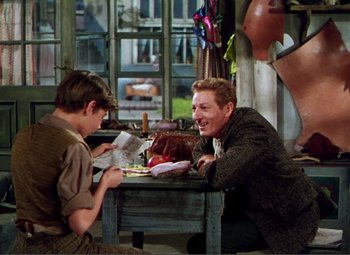 Movie still from “Hans Christian Andersen” (1952), directed by Charles Vidor – A man sitting at a table with another man; Medium shot, Over the shoulder angle